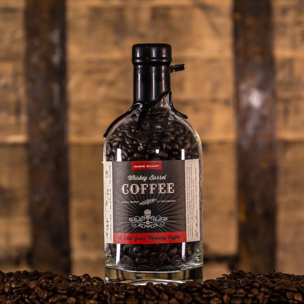 Dark Roast Whiskey Barrel Coffee Bottle with Barrel in Background